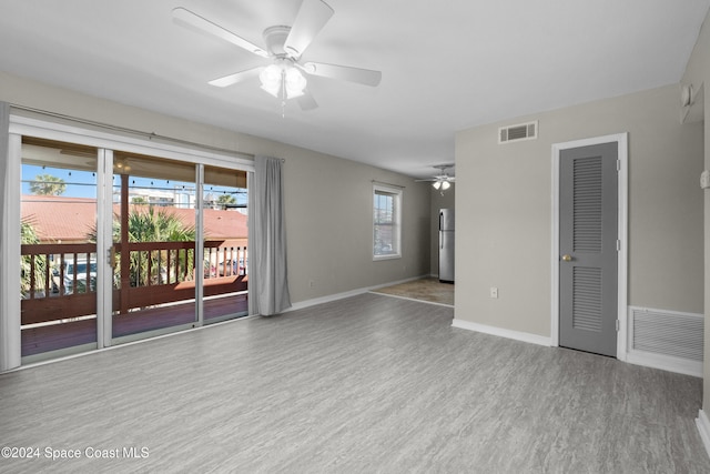 empty room with ceiling fan and light wood-type flooring