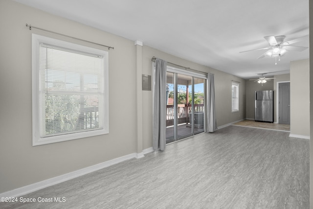 unfurnished room with light wood-type flooring and ceiling fan