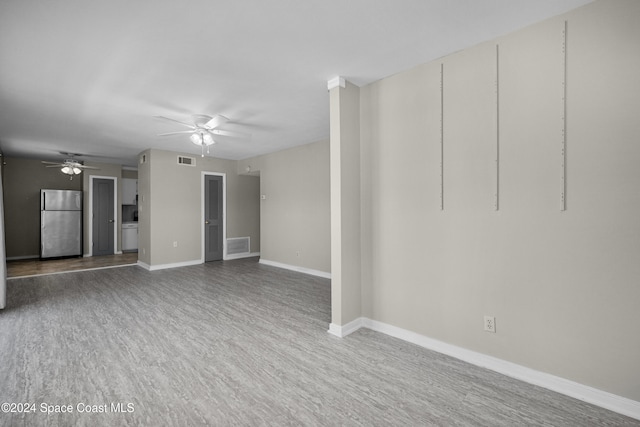 unfurnished living room featuring hardwood / wood-style floors and ceiling fan