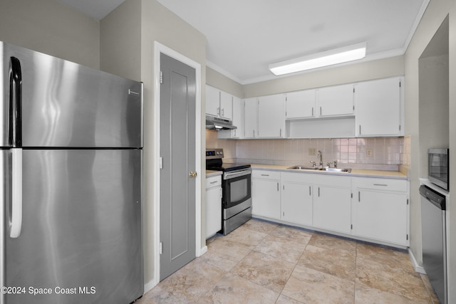 kitchen featuring backsplash, sink, ornamental molding, white cabinetry, and stainless steel appliances