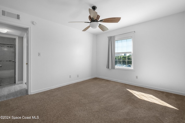 unfurnished room featuring ceiling fan and carpet floors