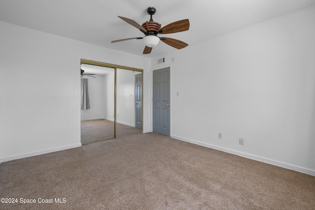 unfurnished bedroom with ceiling fan, carpet floors, and a closet