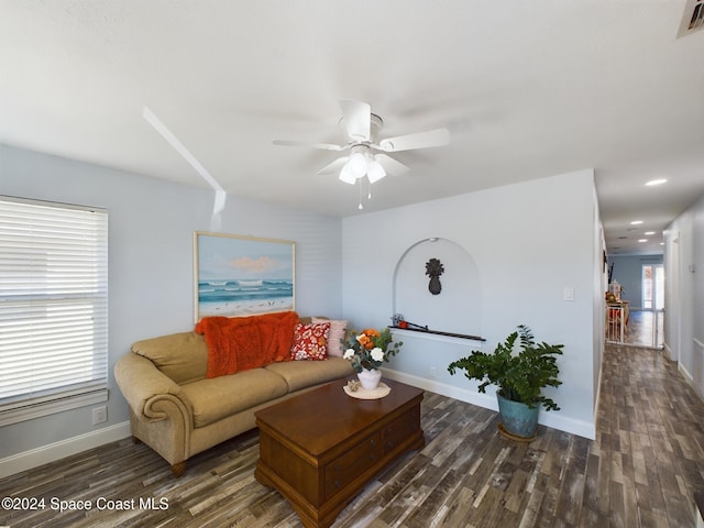 living room with dark hardwood / wood-style floors and ceiling fan