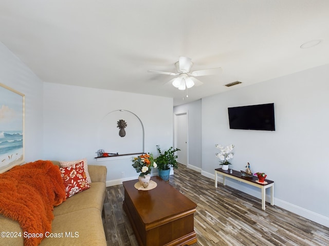 living room featuring hardwood / wood-style floors and ceiling fan