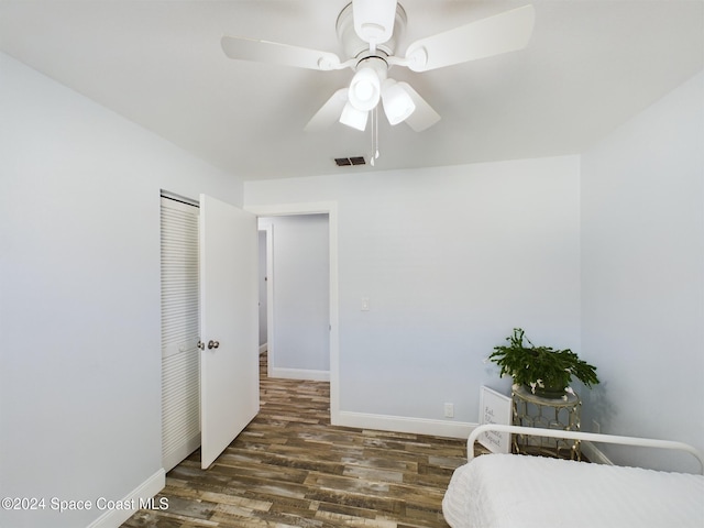 bedroom featuring ceiling fan and dark wood-type flooring