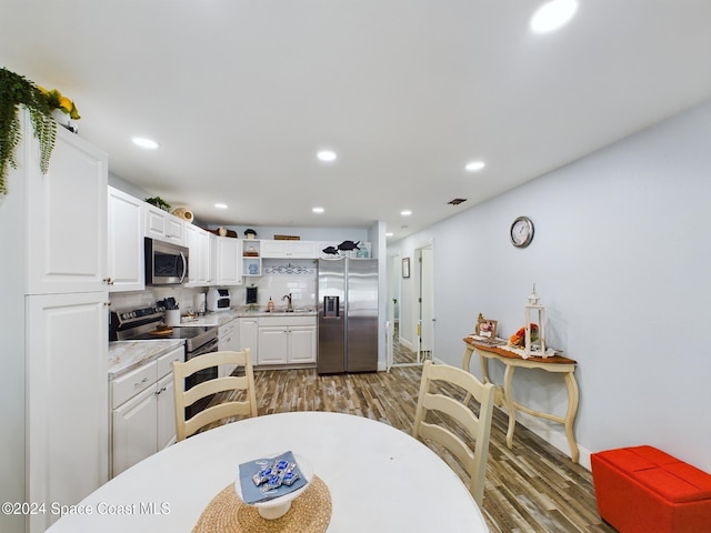 kitchen featuring white cabinetry, sink, appliances with stainless steel finishes, and dark wood-type flooring