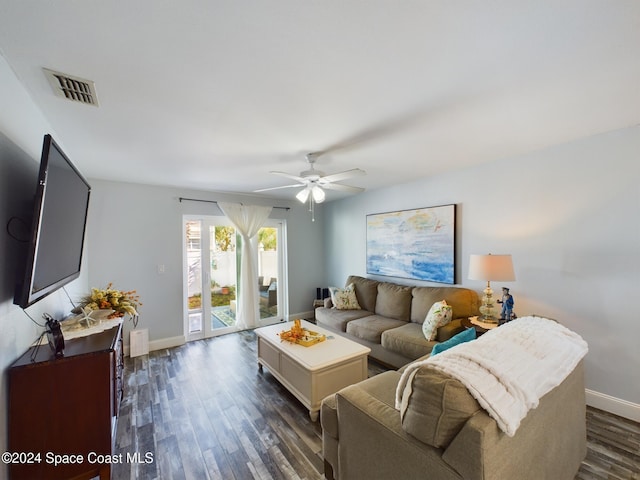 living room with ceiling fan and dark hardwood / wood-style flooring