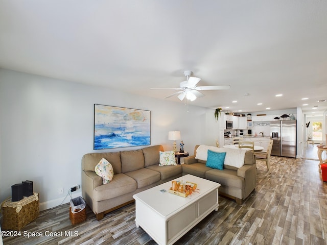 living room featuring ceiling fan and wood-type flooring