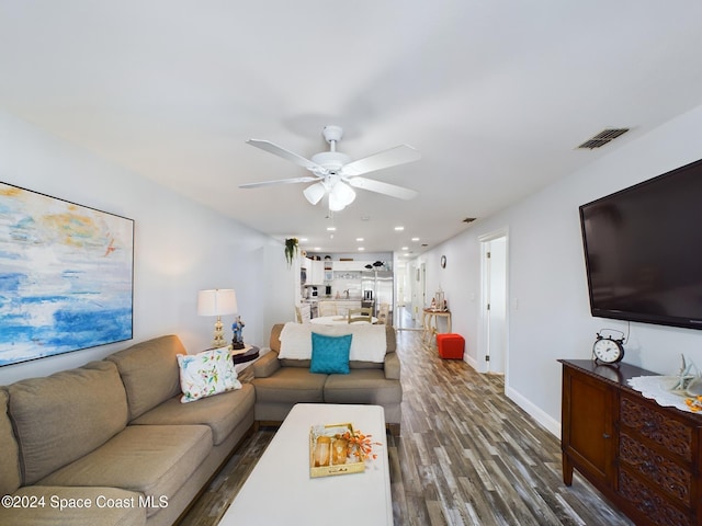 living room featuring hardwood / wood-style flooring and ceiling fan