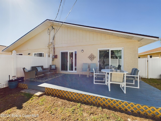 back of house featuring a wooden deck