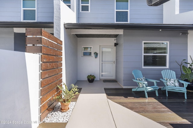 view of exterior entry featuring a wooden deck