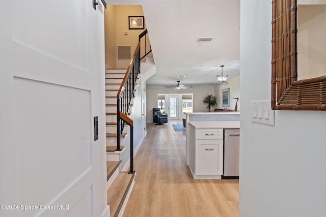 interior space featuring a barn door, french doors, and light hardwood / wood-style floors