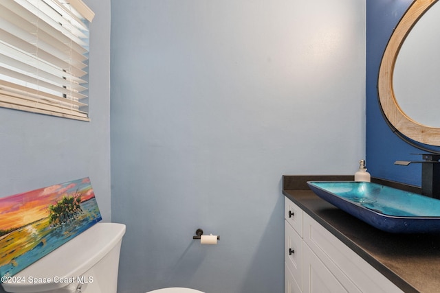 bathroom featuring vanity and toilet