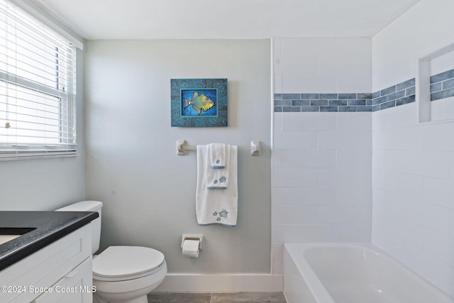 full bathroom with vanity, toilet, and tiled shower / bath