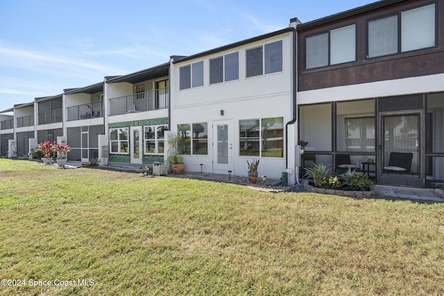 rear view of house featuring a yard