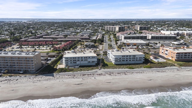 birds eye view of property with a water view and a view of the beach