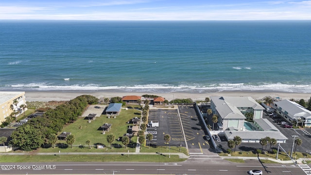 aerial view with a water view and a beach view