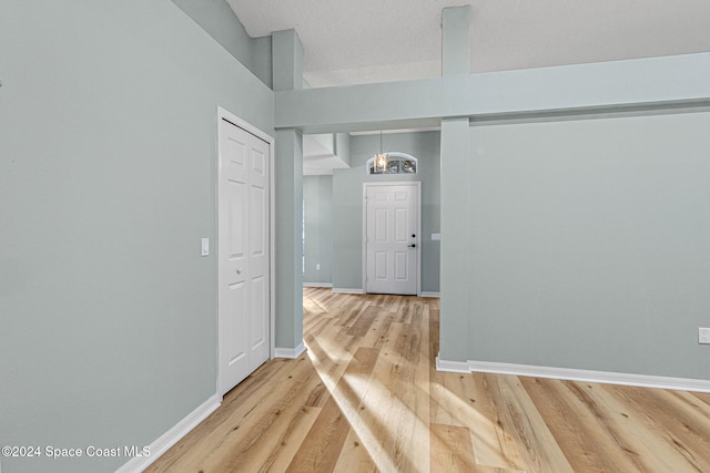 hall with a textured ceiling and hardwood / wood-style flooring