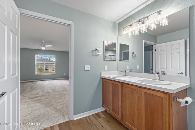 bathroom featuring hardwood / wood-style floors, ceiling fan, and vanity