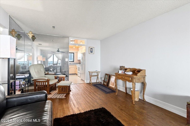 living room with wood-type flooring and a textured ceiling