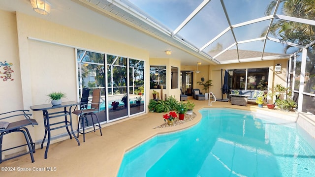 view of pool featuring outdoor lounge area, a lanai, and a patio area