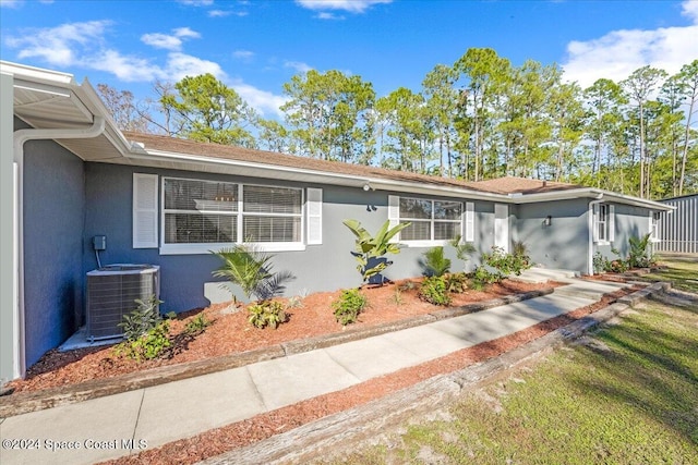 ranch-style home featuring central air condition unit