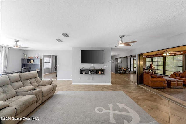 living room with light tile patterned floors and a textured ceiling