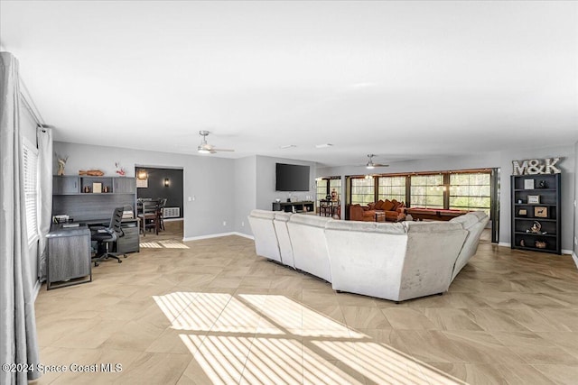 living room featuring ceiling fan and pool table