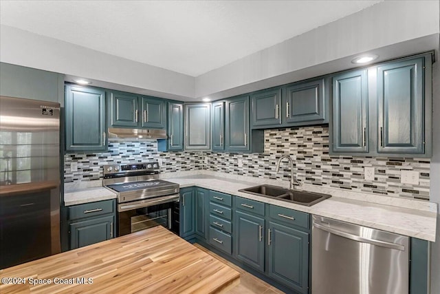 kitchen with decorative backsplash, sink, and stainless steel appliances