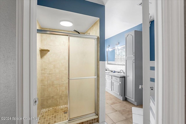 bathroom featuring tile patterned flooring, vanity, and an enclosed shower