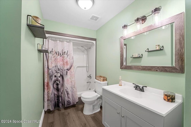 full bathroom featuring toilet, shower / bath combo with shower curtain, vanity, and hardwood / wood-style flooring