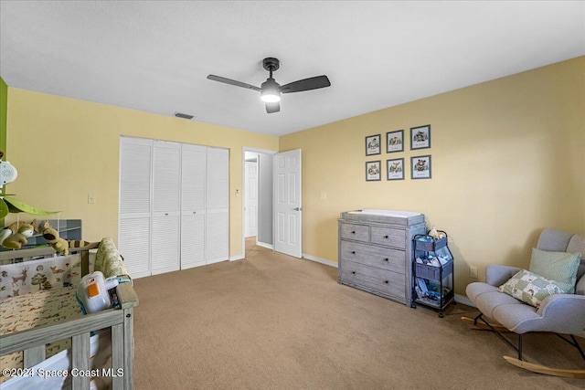 living area featuring ceiling fan and light carpet