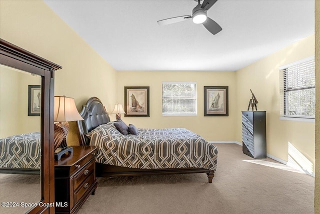 bedroom featuring light carpet and ceiling fan