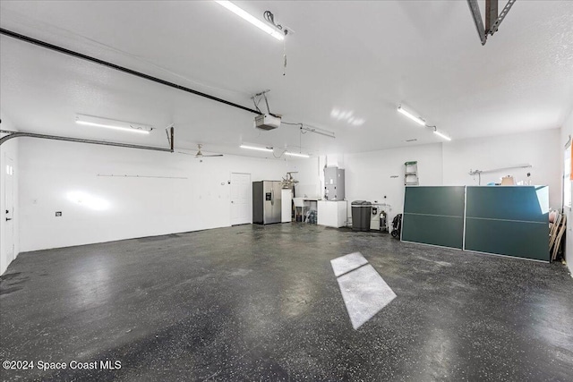 garage featuring a garage door opener and water heater