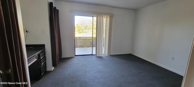 empty room featuring dark colored carpet