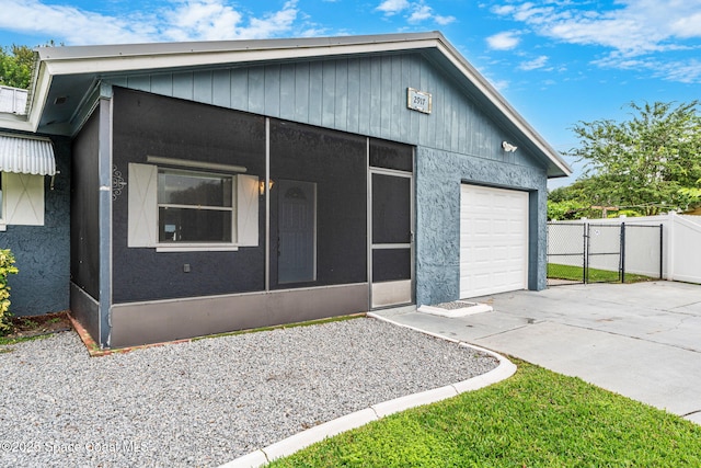 view of front of house featuring a sunroom and a garage