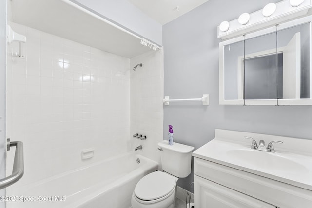 full bathroom with tiled shower / bath, vanity, and toilet