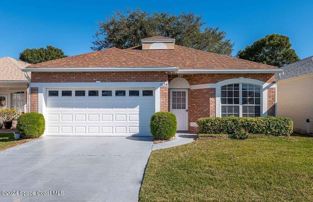 view of front facade with a front yard and a garage