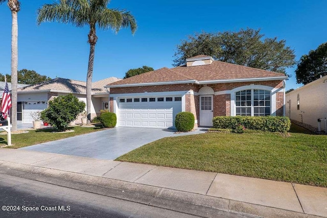 view of front of home featuring a garage and a front lawn