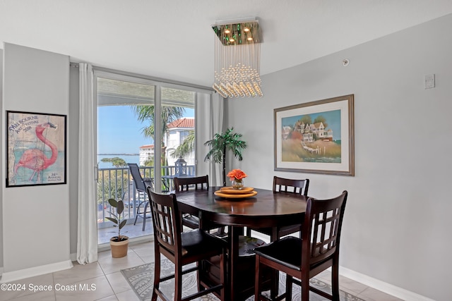 dining area featuring a notable chandelier and light tile patterned floors