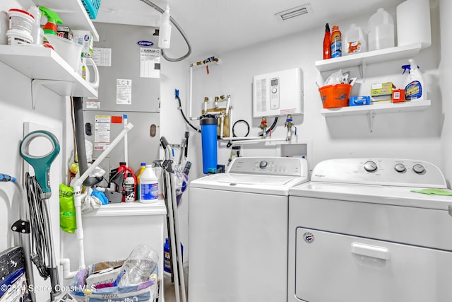 clothes washing area with washing machine and dryer