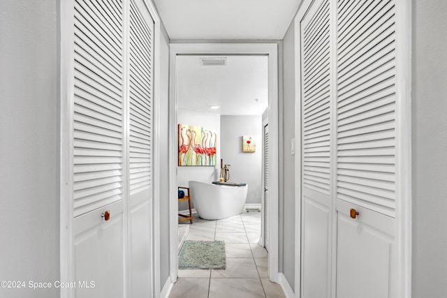 corridor featuring light tile patterned floors