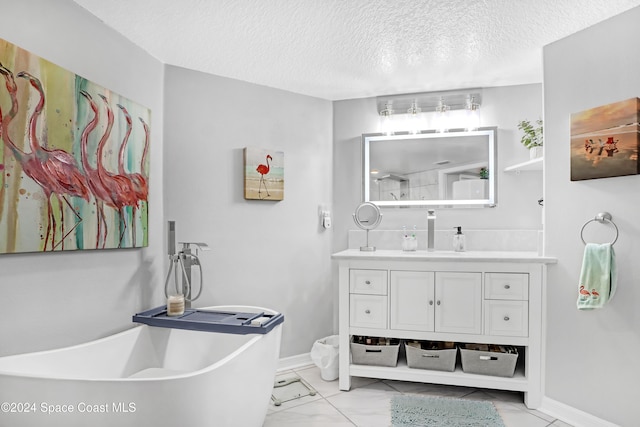 bathroom with vanity, a bath, and a textured ceiling