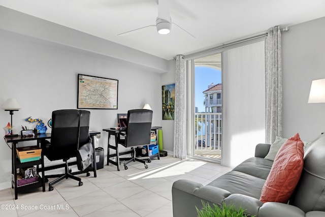 tiled office space featuring ceiling fan