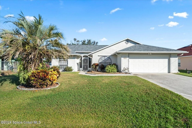 ranch-style home featuring a garage and a front lawn