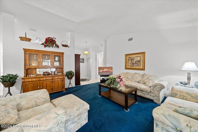 carpeted living room with a textured ceiling and vaulted ceiling