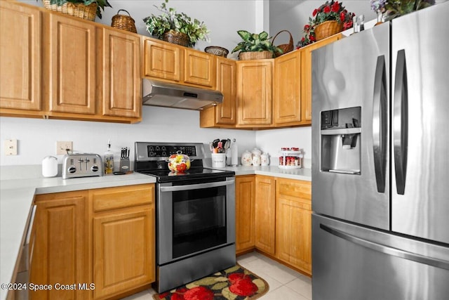 kitchen featuring light tile patterned floors and stainless steel appliances