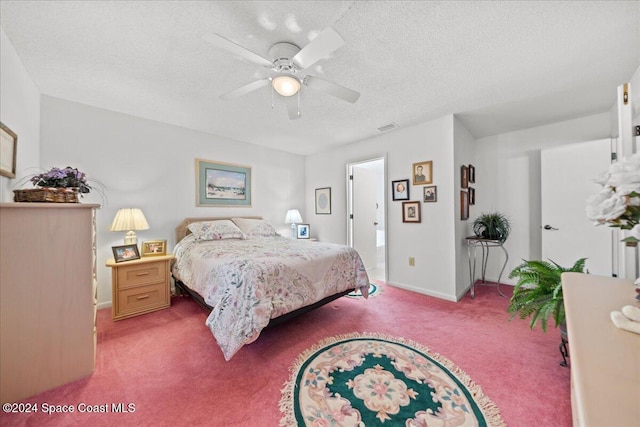 bedroom with carpet flooring, a textured ceiling, and ceiling fan