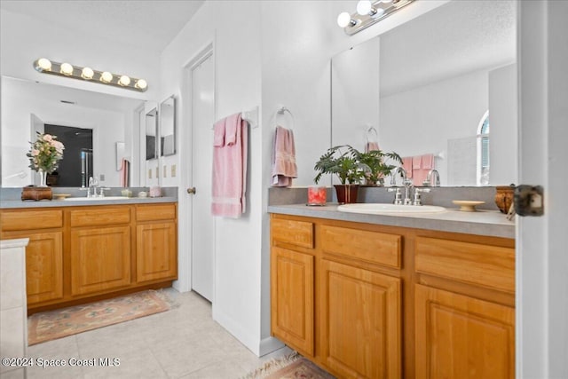 bathroom featuring tile patterned flooring and vanity