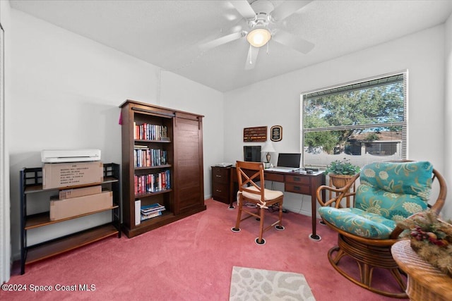 carpeted home office featuring a textured ceiling and ceiling fan